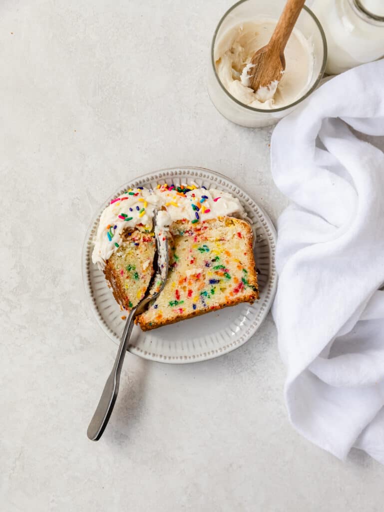 overhead shot of a slice of funfetti cake with fork 