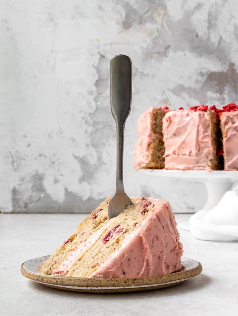 fork in a piece of  strawberry cake 