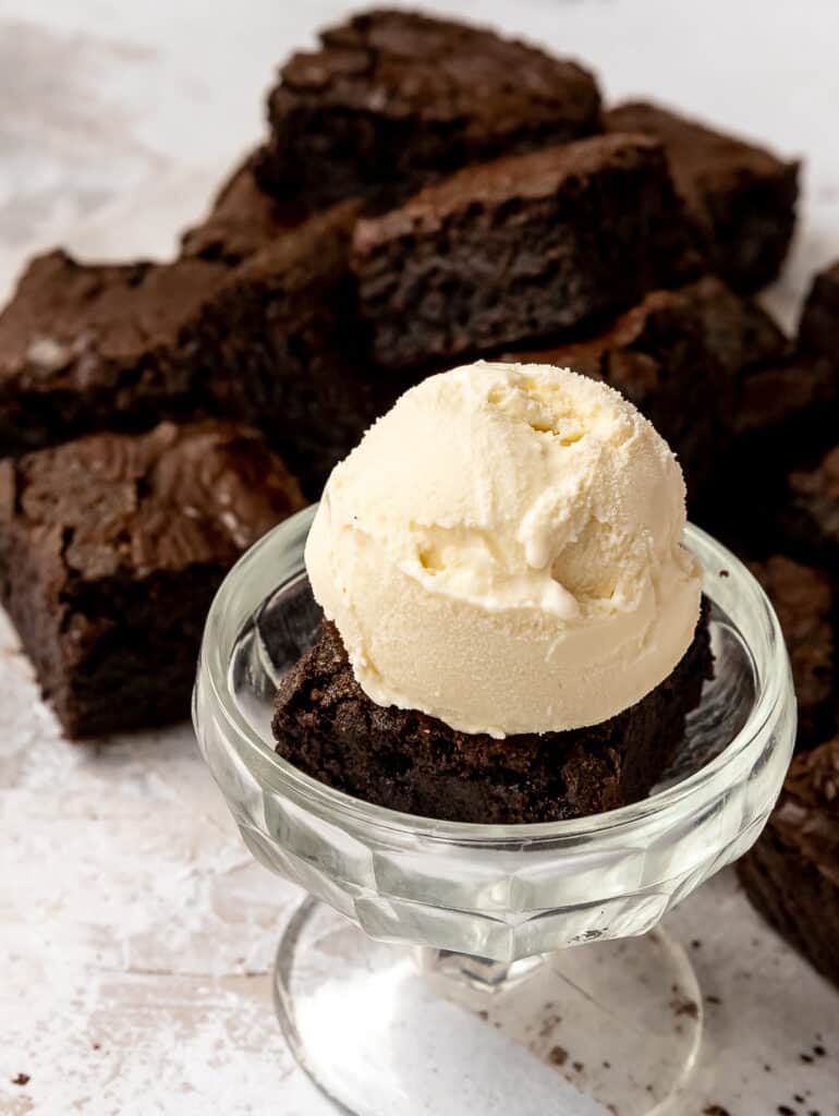 triple chocolate lavender brownies in a cup with a scoop of ice cream 