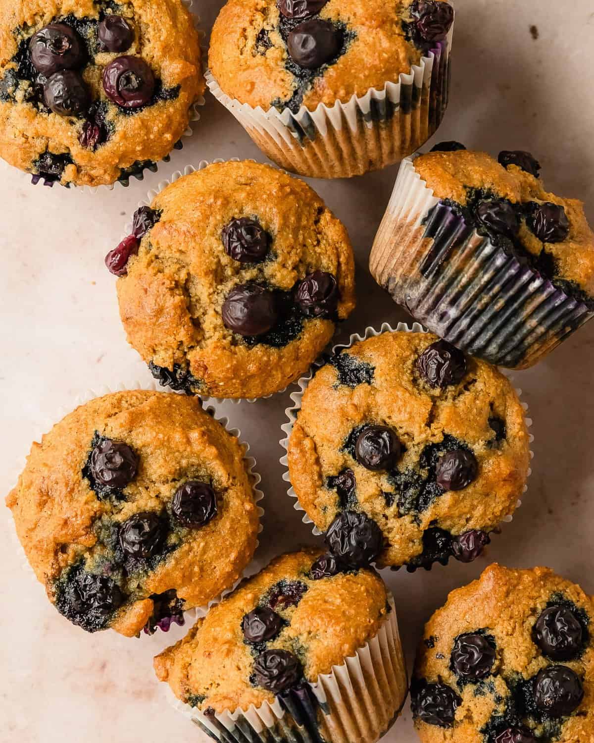 These almond flour blueberry muffins are quick and easy,  gluten-free muffins filled with fresh blueberries. This recipe for blueberry almond flour muffins is easy to make using simple, healthy ingredients. They’re moist, nutty, filled with cinnamon and blueberry flavor and are perfect for breakfasts and snacks.