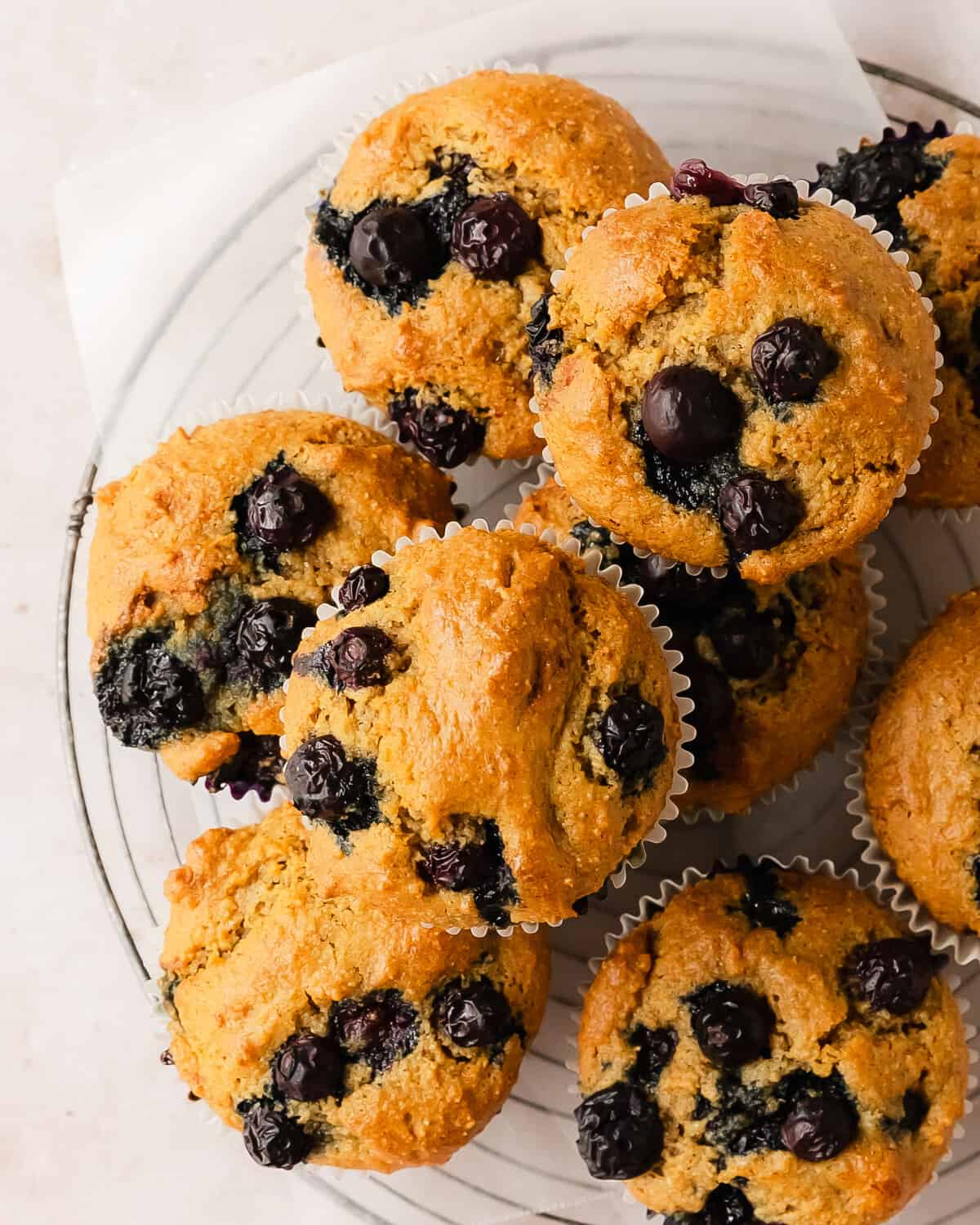 These almond flour blueberry muffins are quick and easy,  gluten-free muffins filled with fresh blueberries. This recipe for blueberry almond flour muffins is easy to make using simple, healthy ingredients. They’re moist, nutty, filled with cinnamon and blueberry flavor and are perfect for breakfasts and snacks. 