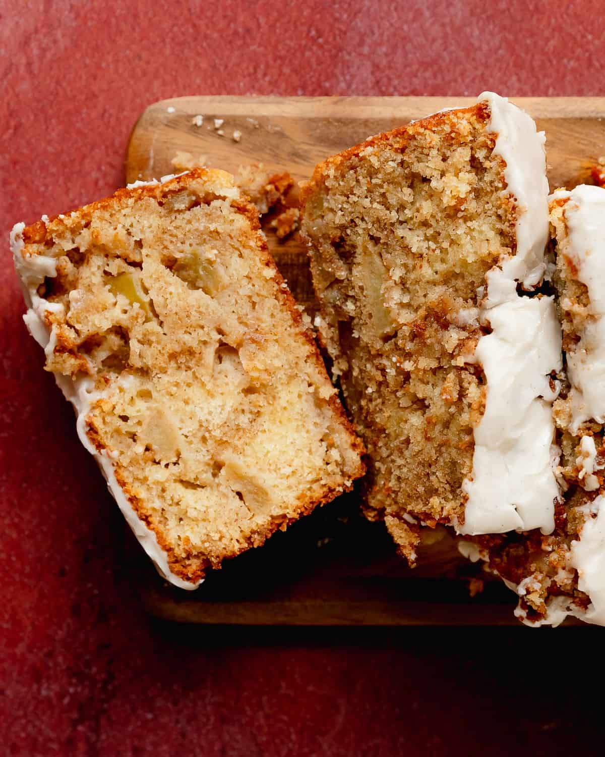 Apple fritter bread is a soft, moist and flavor packed apple quick bread with brown sugar cinnamon apples swirled throughout. The spiced apple fritter topping is also swirled on the apple bread giving you cozy, caramelized apple chunks in every bite. Make this Amish apple bread truly decadent by topping it with an easy vanilla bean glaze. 