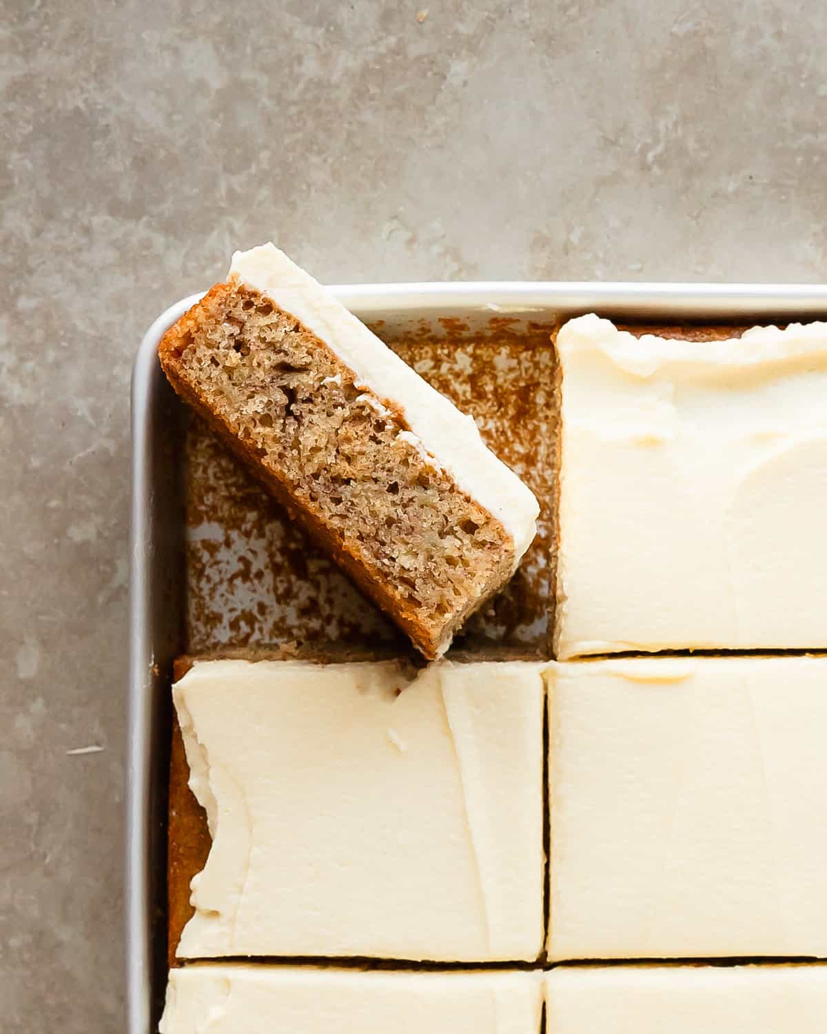 Banana bars with cream cheese frosting are soft, moist and flavorful banana cake bars; topped with a rich and sweet cream cheese frosting. Grab two bowls and a whisk to make this sheet cake banana bars recipe the next time you need a quick and easy dessert that everyone is sure to love!