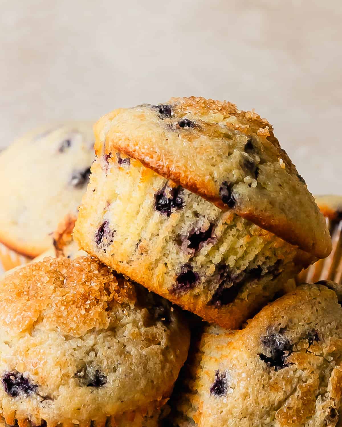 These buttermilk blueberry muffins are light, fluffy and incredibly moist buttermilk muffins filled with fresh blueberries. They’re bakery style muffins with beautiful tall, domed tops covered in crunchy bits of sparkling sugar. This quick and easy blueberry buttermilk muffin recipe makes the best blueberry muffins you’ll want to make over and over again.