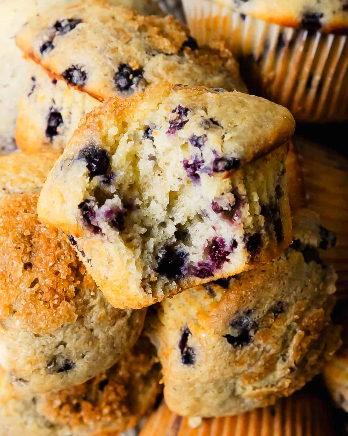 These buttermilk blueberry muffins are light, fluffy and incredibly moist buttermilk muffins filled with fresh blueberries. They’re bakery style muffins with beautiful tall, domed tops covered in crunchy bits of sparkling sugar.
