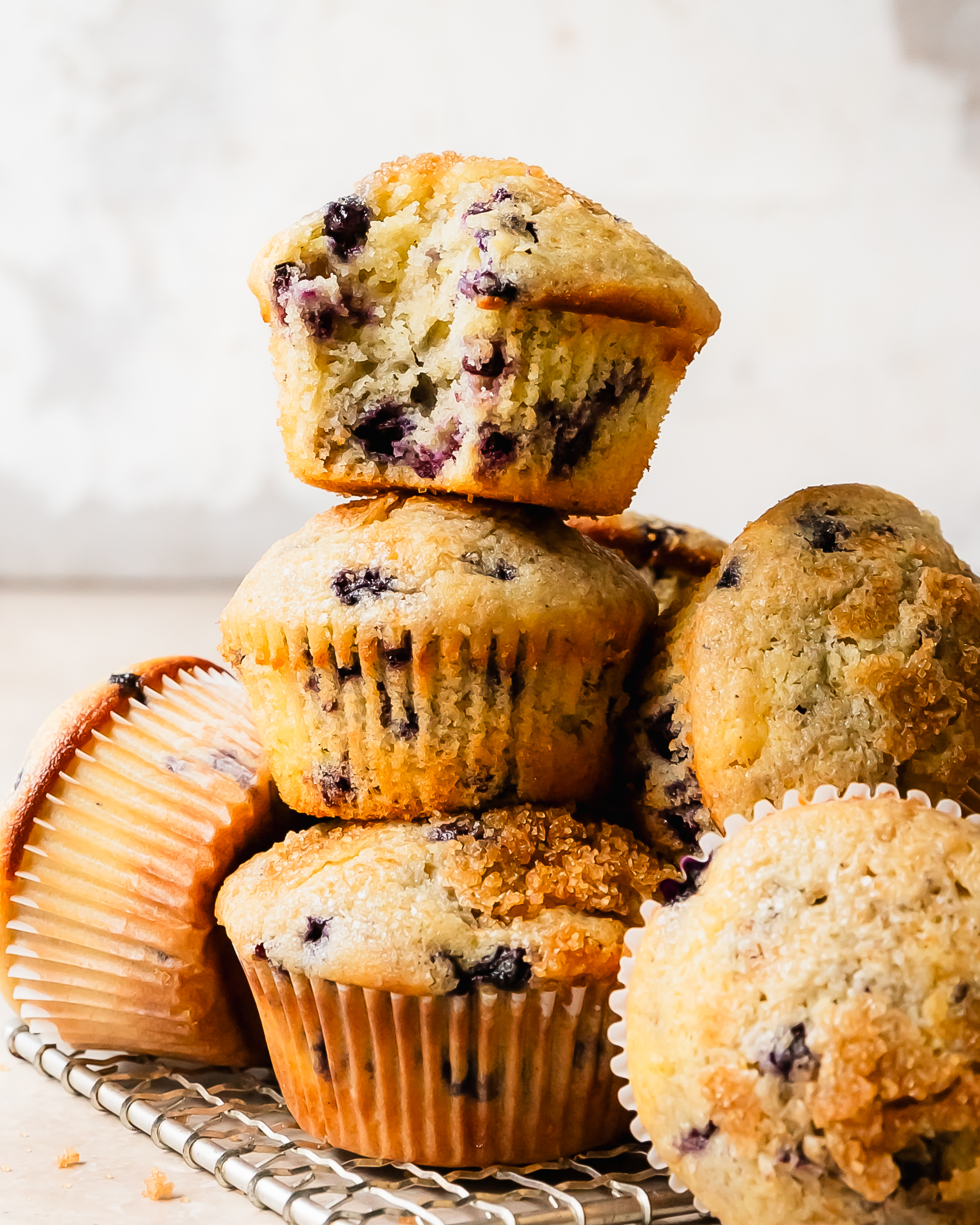 These buttermilk blueberry muffins are light, fluffy and incredibly moist buttermilk muffins filled with fresh blueberries. They’re bakery style muffins with beautiful tall, domed tops covered in crunchy bits of sparkling sugar. 