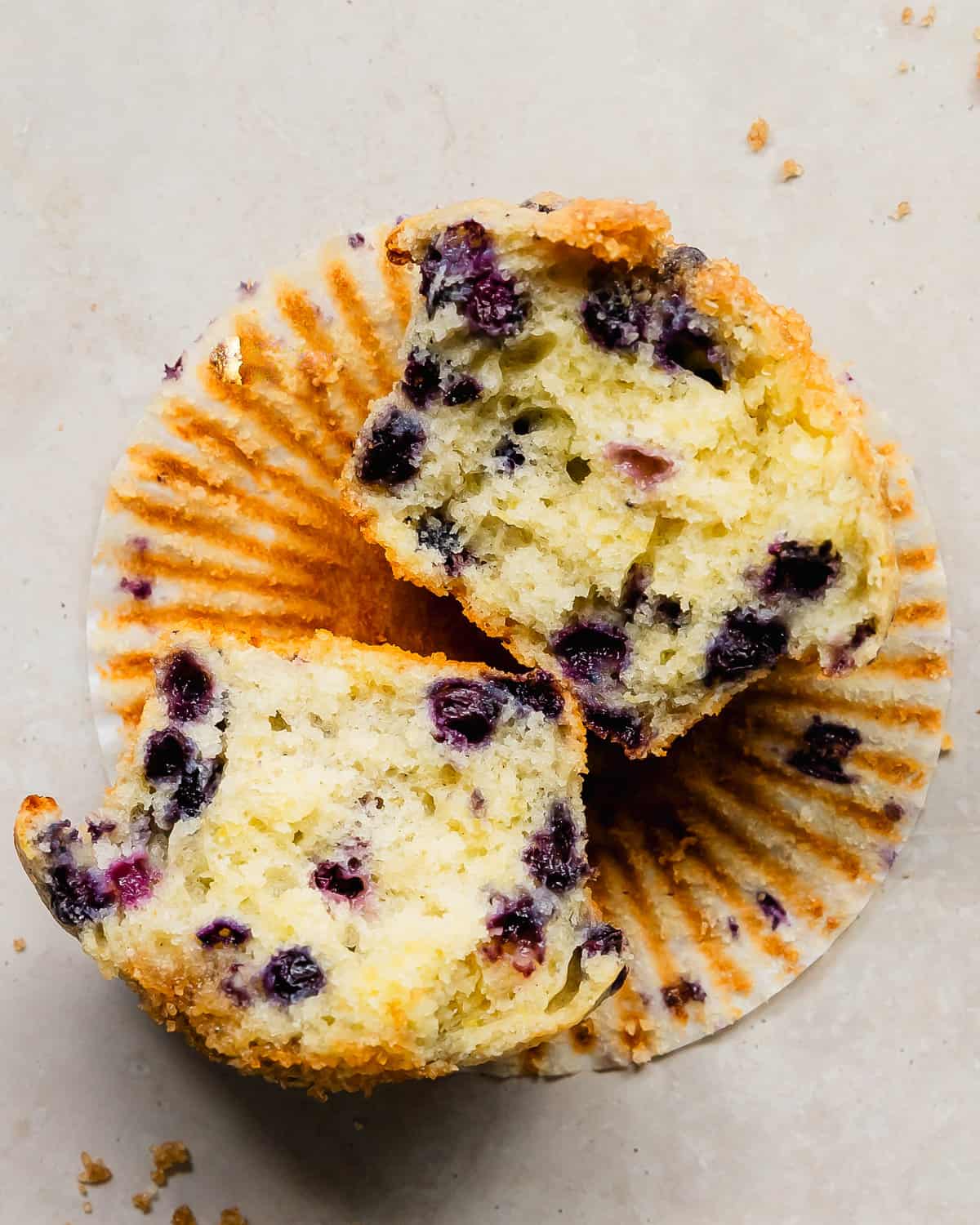 These buttermilk blueberry muffins are light, fluffy and incredibly moist buttermilk muffins filled with fresh blueberries. They’re bakery style muffins with beautiful tall, domed tops covered in crunchy bits of sparkling sugar.