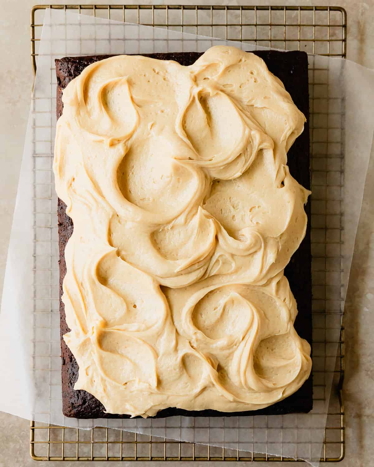 Chocolate banana cake is a moist and tender, from scratch chocolate cake filled with banana flavor. It’s topped with a rich and decadent peanut butter cream cheese frosting and shaved chocolate. This banana chocolate cake is not only quick and simple to make using two bowls and a whisk, it’s also the easy perfect cake for any occasion. 