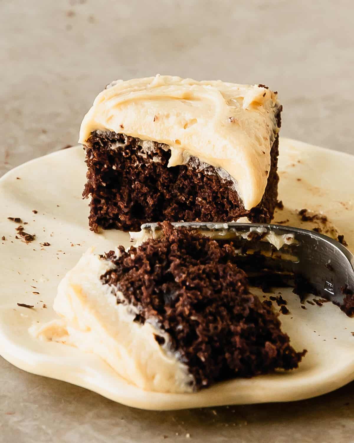 Chocolate banana cake is a moist and tender, from scratch chocolate cake filled with banana flavor. It’s topped with a rich and decadent peanut butter cream cheese frosting and shaved chocolate. This banana chocolate cake is not only quick and simple to make using two bowls and a whisk, it’s also the easy perfect cake for any occasion.