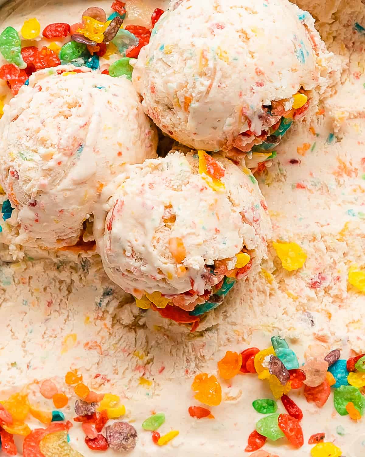 Fruity Pebbles ice cream is an easy and creamy, no churn cereal milk ice cream infused with fruity pebbles flavor. The only ingredients you need to make this fruity ice cream is fruity cereal, heavy cream, sweetened condensed milk, juice and vanilla extract. Simply mix, layer, freeze and enjoy! 