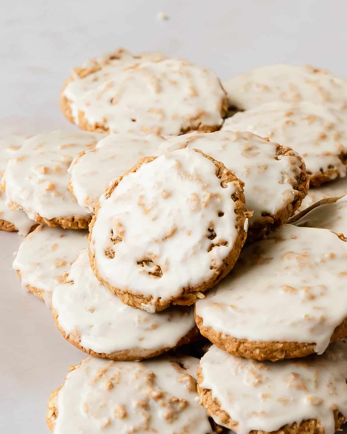 Iced oatmeal cookies are soft and chewy cookies filled with cozy spices, topped with a vanilla icing.  What I love most about these frosted oatmeal cookies are that they require no chill chilling time and are super easy to make. These old-fashioned oatmeal cookies are the perfect cozy cookie everyone will love!