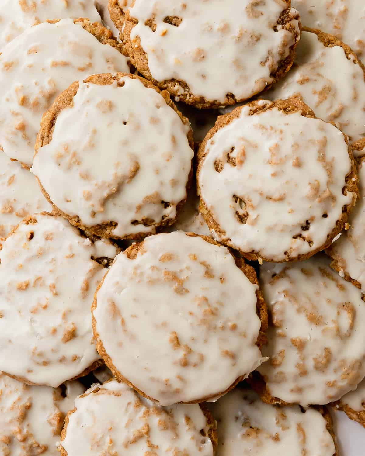 Iced oatmeal cookies are soft and chewy cookies filled with cozy spices, topped with a vanilla icing.  What I love most about these frosted oatmeal cookies are that they require no chill chilling time and are super easy to make. These old-fashioned oatmeal cookies are the perfect cozy cookie everyone will love!