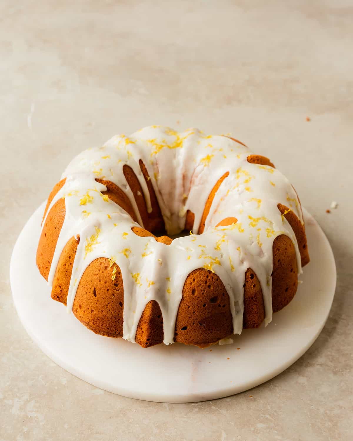 Lemon cream cheese pound cake is a decadent, dense and buttery lemon pound cake made with cream cheese. Top this lemon cake with a sweet and tart lemon glaze for even more lemon flavor. Enjoy this easy to make, old fashioned lemon pound cake for breakfast, brunch or dessert. 