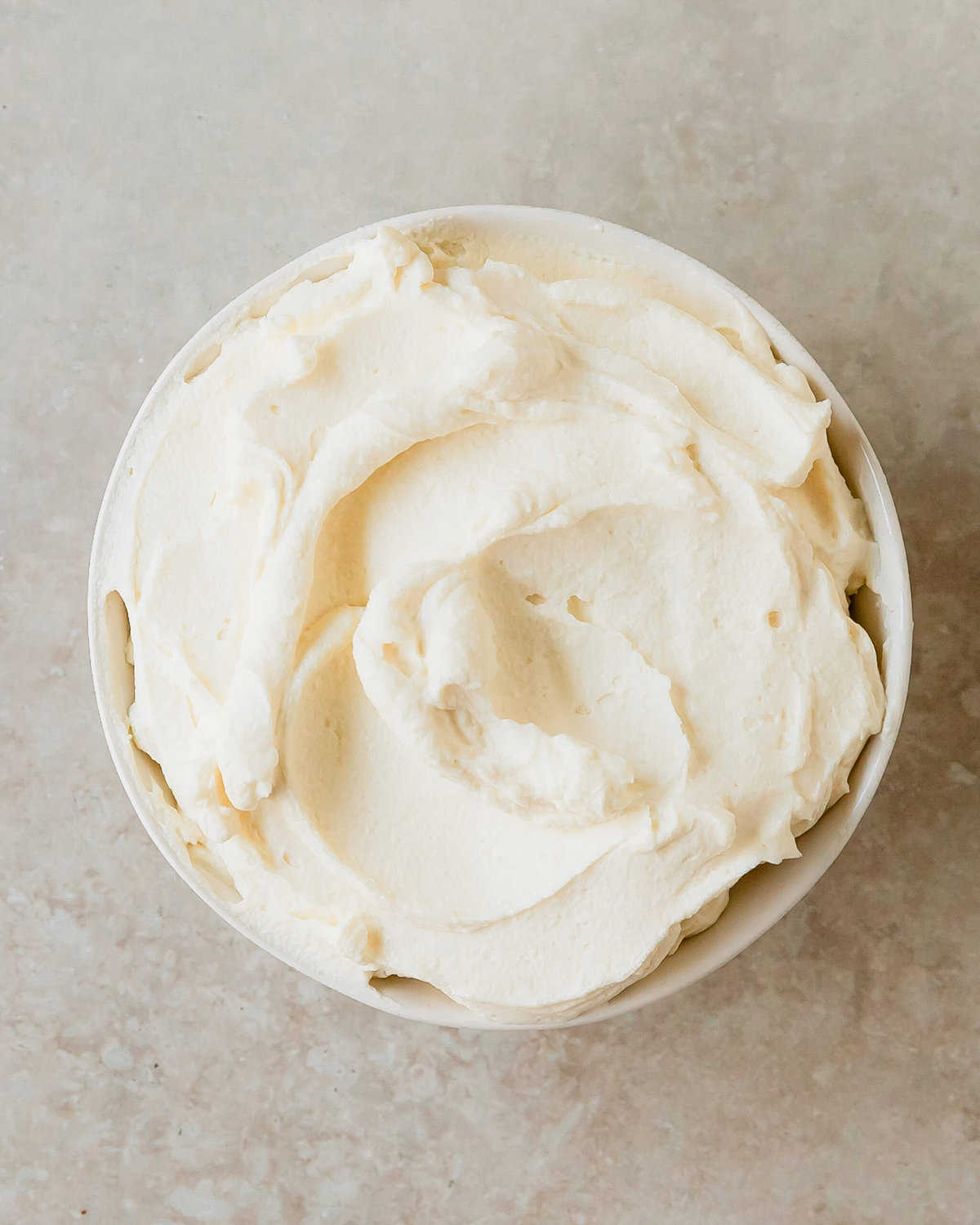 Mascarpone frosting is a decadent, creamy and lusciously silky smooth frosting that’s perfect for topping cakes, cupcakes, brownies and cookies.  This mascarpone whipped cream frosting is made from 4 simple ingredients and is incredibly easy to make. Reach for this mascarpone icing the next time you need an incredibly delicious, but not too sweet frosting recipe. 