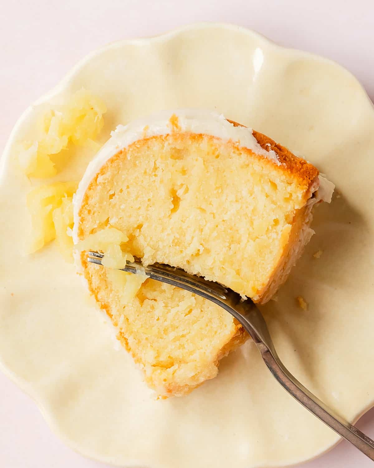 This pineapple pound cake is a rich, dense and tender cake filled with crushed sweet, tropical pineapple. Top with this pineapple cake with a bright and creamy pineapple glaze. Enjoy this easy to make, tropical twist on old fashioned pound cake for breakfast, brunch or dessert. 