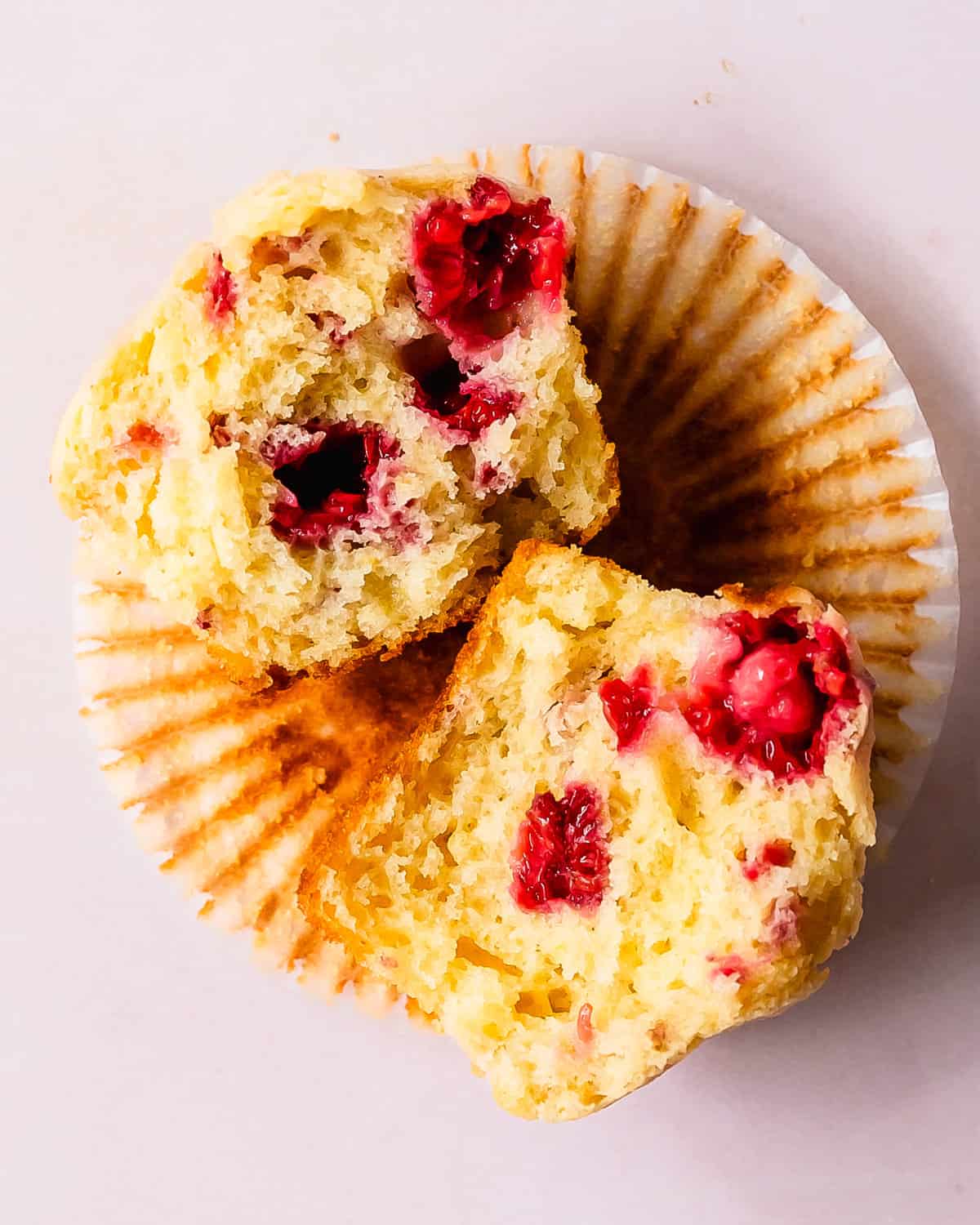 These raspberry muffins are light, fluffy and incredibly moist bakery style muffins filled with fresh or frozen raspberries and a hint of lemon.