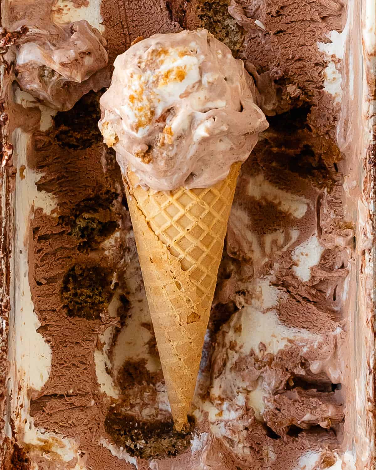 Tiramisu ice cream is an rich, sweet and creamy, coffee infused mascarpone ice cream filled with pieces of espresso soaked ladyfingers and is topped with a dusting of cocoa powder. Learn how to make this no churn ice cream inspired by the classic Italian dessert in a few easy steps with just a handful of ingredients.