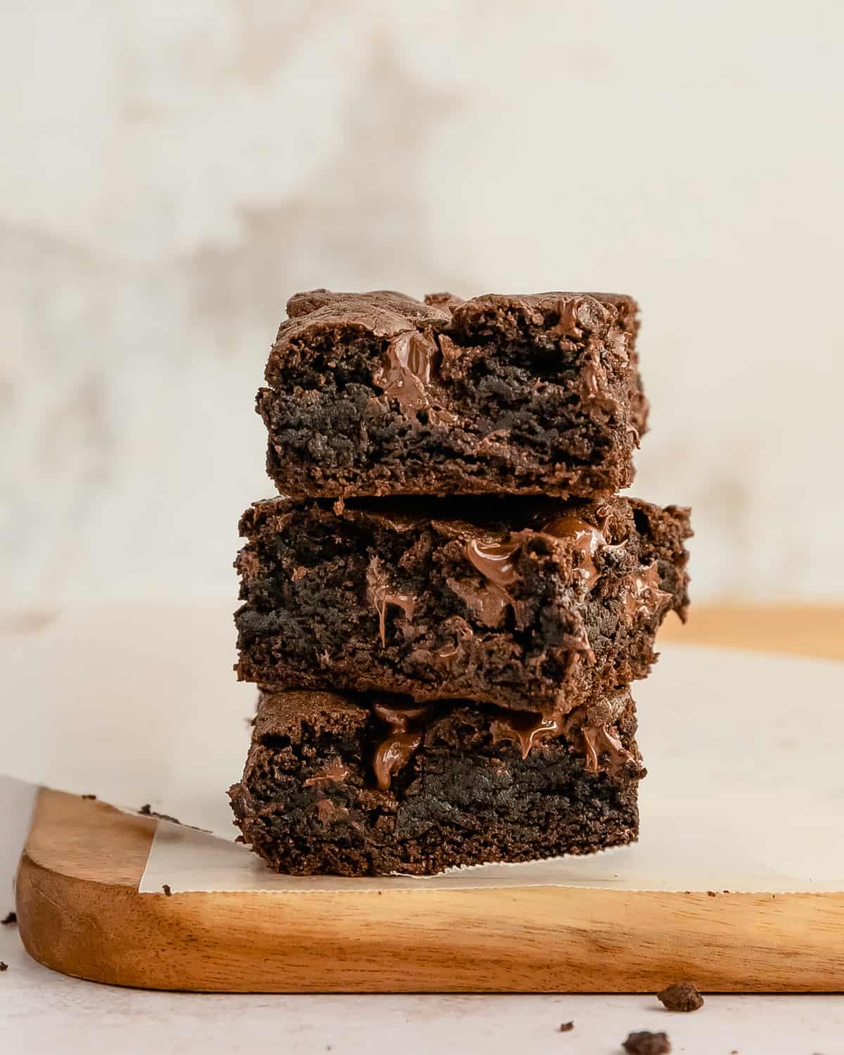 Rich Cake Mix Brownie squares stacked on a cutting board.