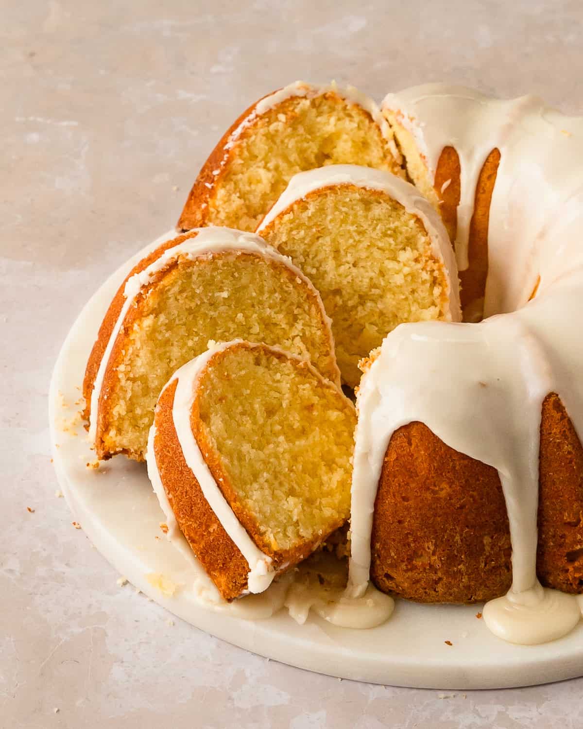 Lemonade bundt cake with lemon glaze on a serving plate.