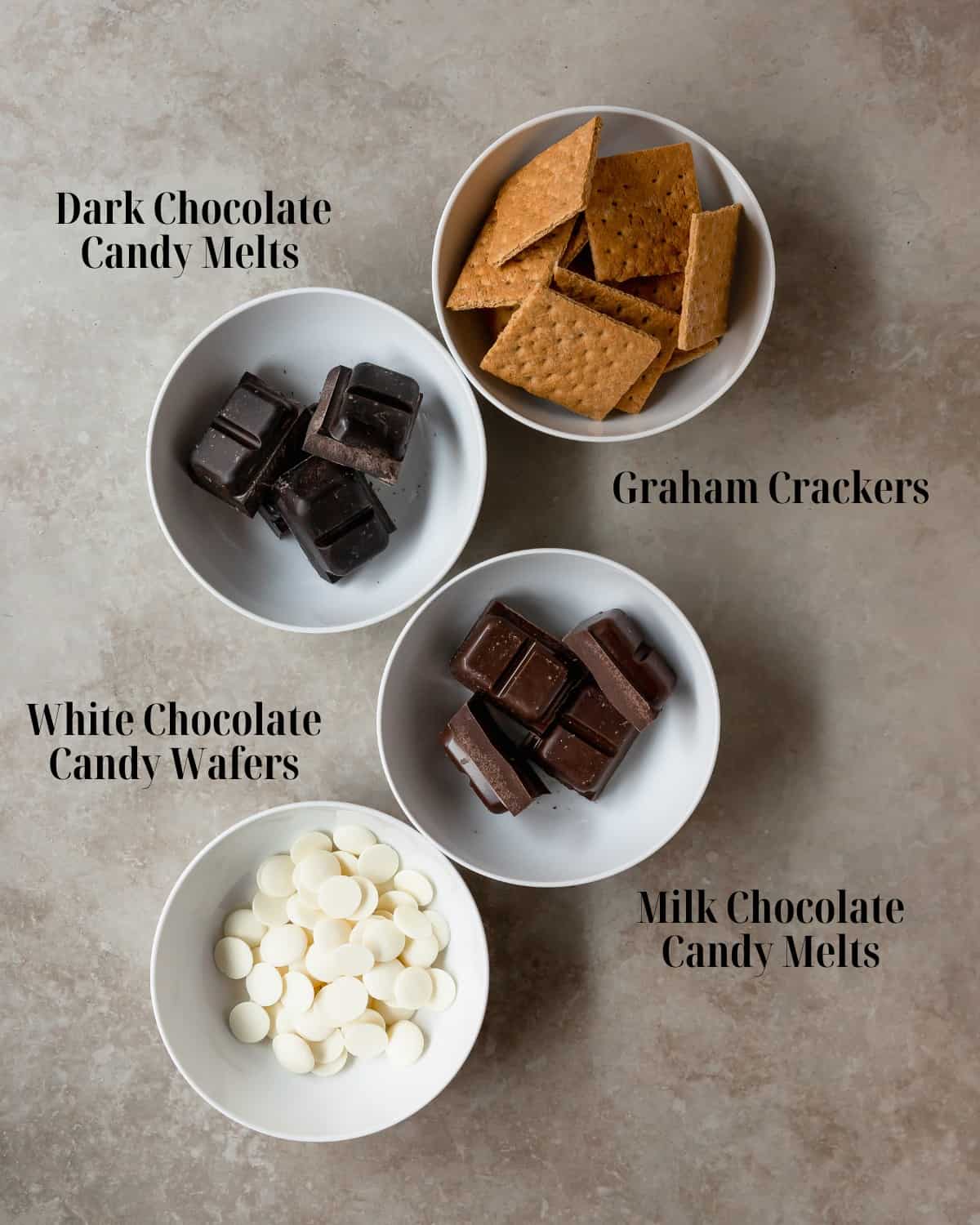 Gather graham crackers, white chocolate, milk chocolate, and dark chocolate melting candies and any toppings you like.