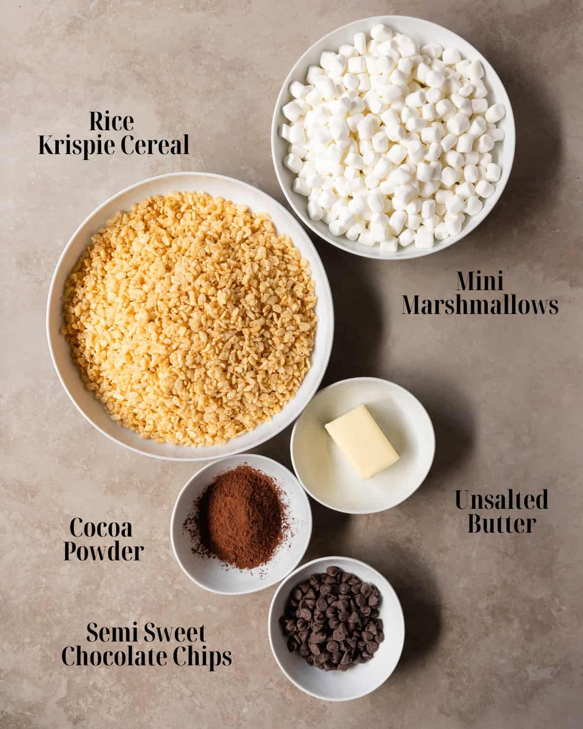 Gather rice krispie cereal, butter, mini marshmallows, cocoa powder, chocolate chips and flaky salt.