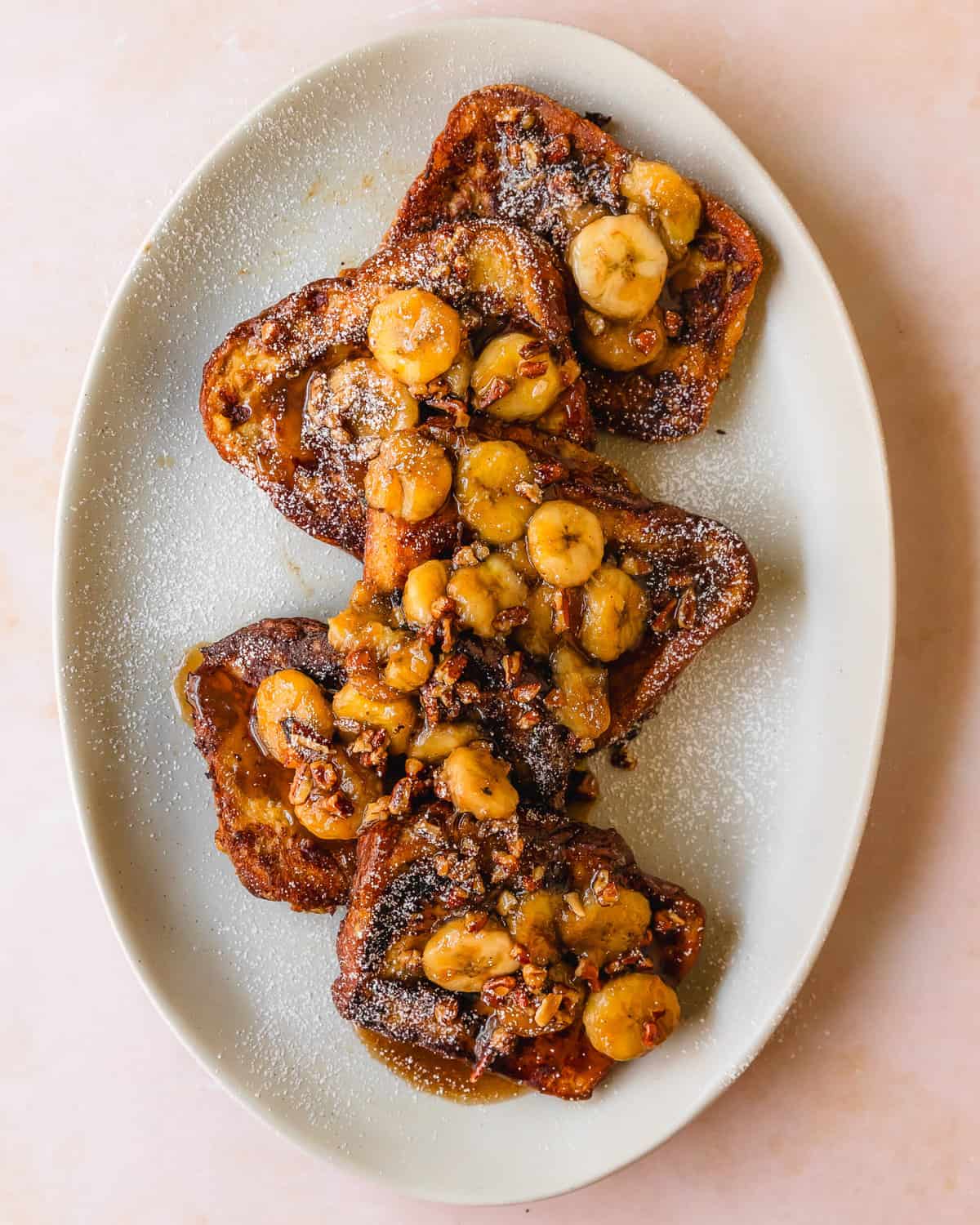 Banana french toast is a simple and decadent french toast made from buttery bread soaked in a rich banana custard, fried to golden perfection. It’s topped with caramelized bananas and chopped nuts. This quick and easy french toast with bananas makes the perfect indulgent breakfast or brunch. 