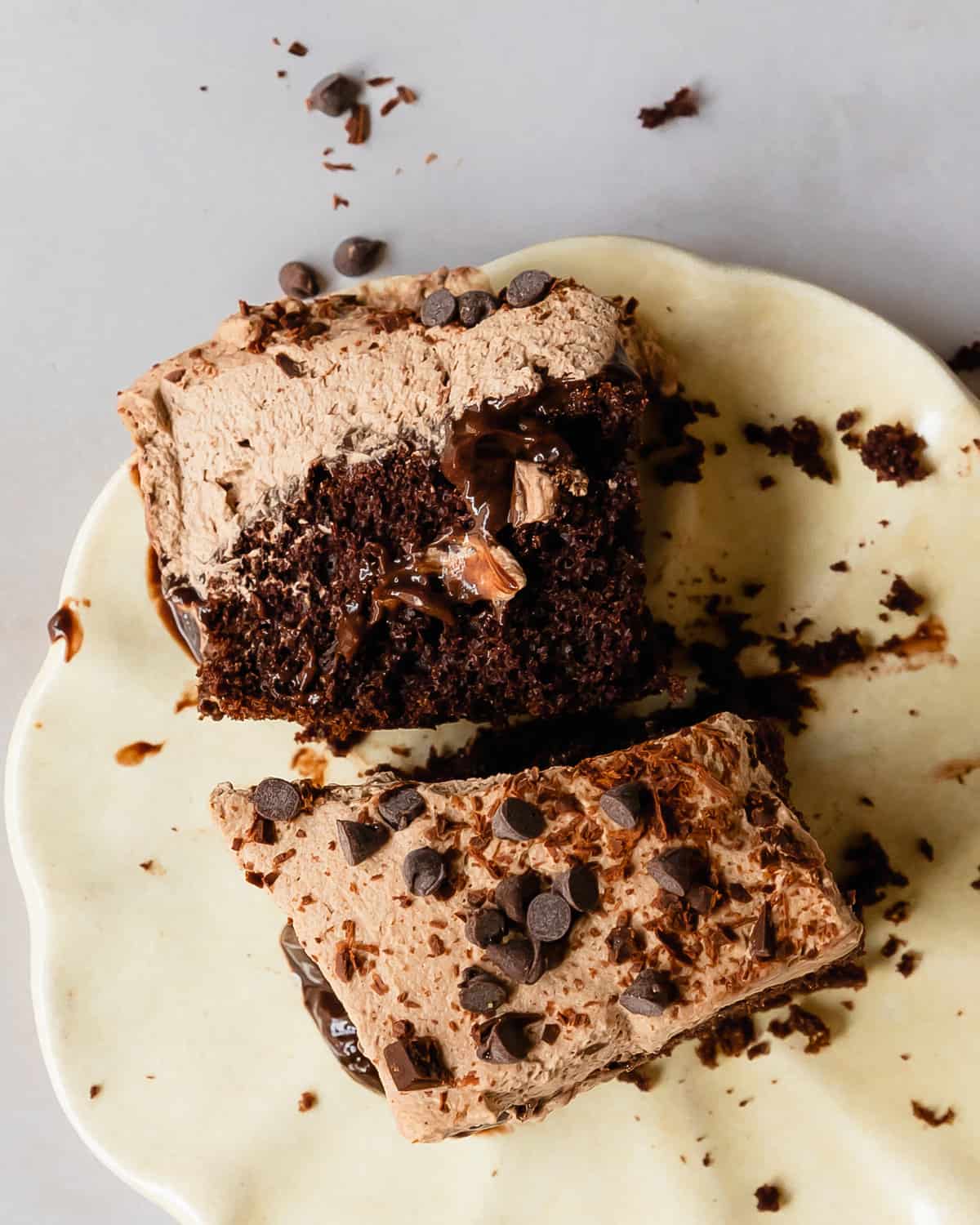 Chocolate poke cake is a decadent triple chocolate pudding cake. It’s made with moist chocolate devil’s food cake filled with a creamy chocolate pudding, layered with fluffy chocolate whipped cream and chocolate chips. This chocolate pudding cake recipe comes together quickly and easily, making this the perfect dessert for gatherings and celebrations. 