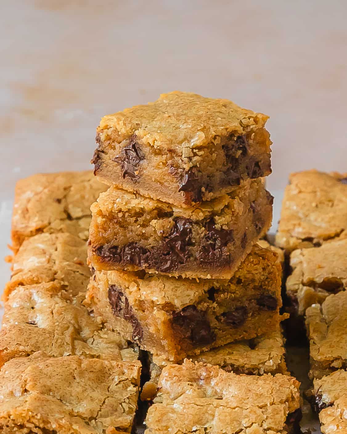 Brown butter blondies are thick and chewy blondie brownies with delicate crackle tops.  These simple blondies are filled with nutty browned butter flavor which pairs perfectly with the caramel, butterscotch and vanilla that is classic in the best blondies. Add a handful of chocolate chips for even more drool worthy flavor.