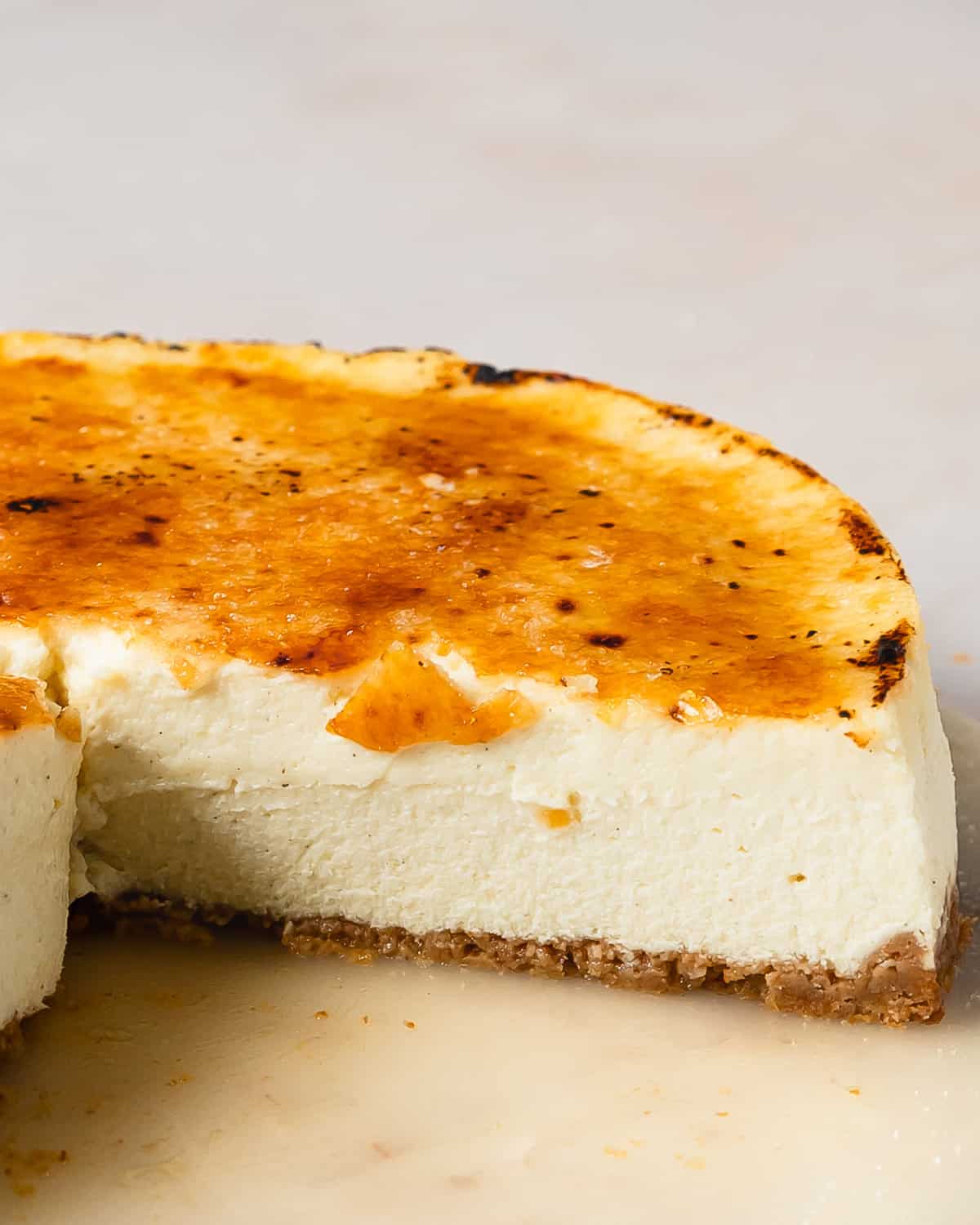 Creme Brulee Cheesecake is a thick, rich and creamy vanilla bean cheesecake with a classic graham cracker crust. This decadent cheesecake is topped with a beautiful golden brown bruleed sugar crust. Make this brulee cheesecake the next time you need a simple, stunning and celebratory dessert.