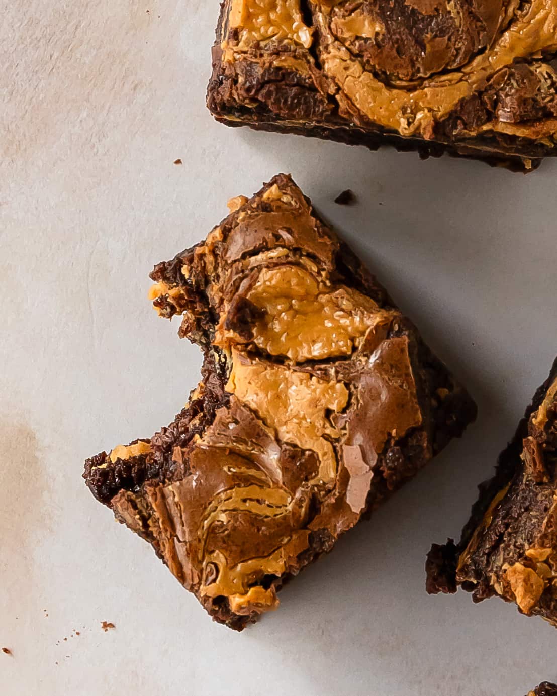 Peanut butter brownies are rich and fudgy brownies stuffed with a layer of creamy peanut butter filling. Top these easy and chewy stuffed brownies with swirls of peanut butter for even more decadent chocolate and peanut butter cup flavor.