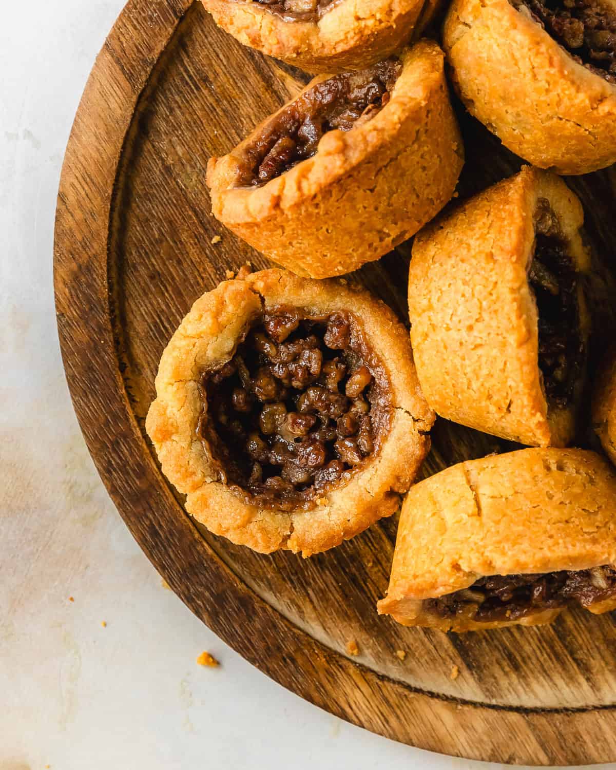  Pecan pie cookies are deliciously soft and buttery brown sugar cookie cups filled with a classic pecan pie filling.  This recipe for pecan pie cookies are easy to make, require no chilling time and are ready in about 30 minutes. These pecan cookies are a fun twist on the classic pecan pie dessert everyone will love. 