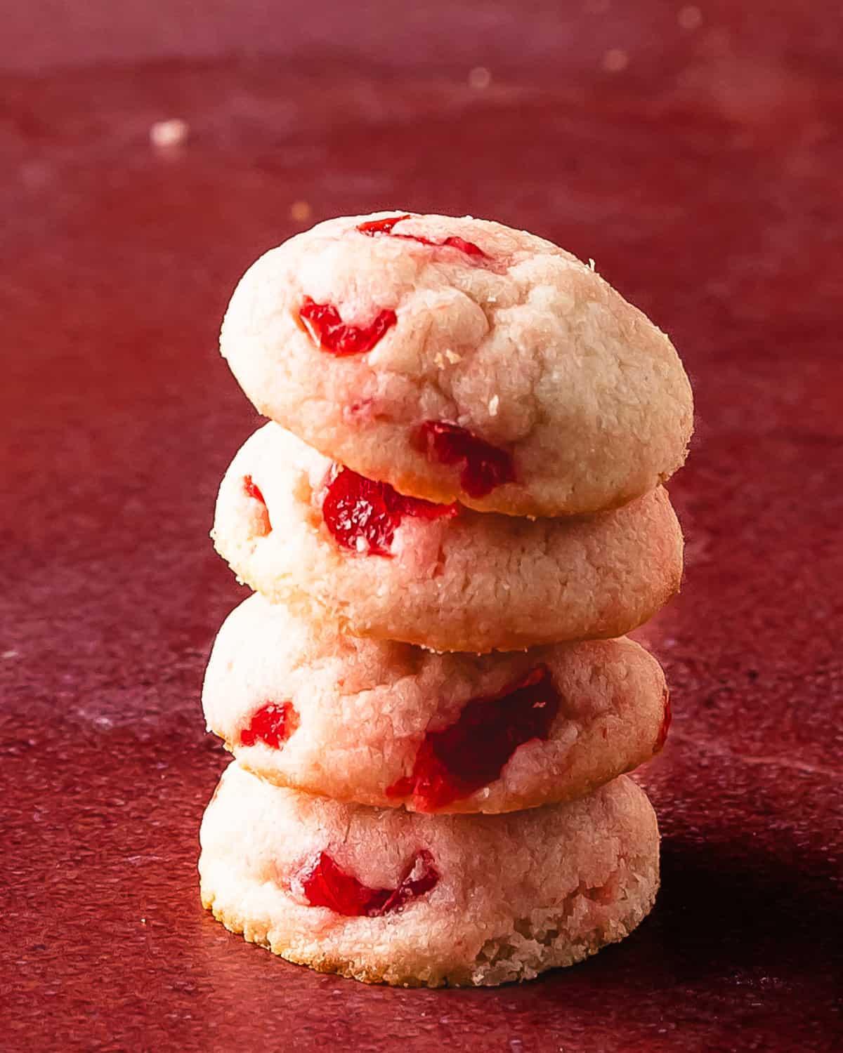 Cherry cookies are soft and buttery shortbread style drop cookies filled with maraschino cherries and sweet almond flavor. These pretty pink maraschino cherry cookies are the perfect quick and easy cherry sugar cookie recipe for any occasion. 