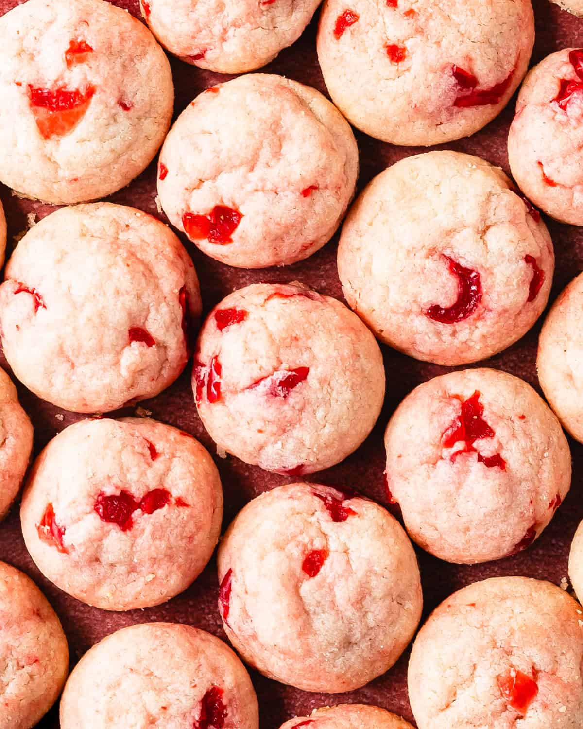 Cherry cookies are soft and buttery shortbread style drop cookies filled with maraschino cherries and sweet almond flavor. These pretty pink maraschino cherry cookies are the perfect quick and easy cherry sugar cookie recipe for any occasion. 