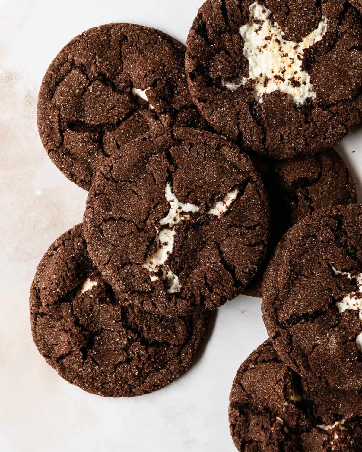Chocolate marshmallow cookies are fudgy and chewy double chocolate sugar cookies filled with gooey marshmallows, rolled in a sweet, crunchy sugar coating. These marshmallow cookies are incredibly quick and easy to make and taste just like your favorite hot cocoa with marshmallows.
