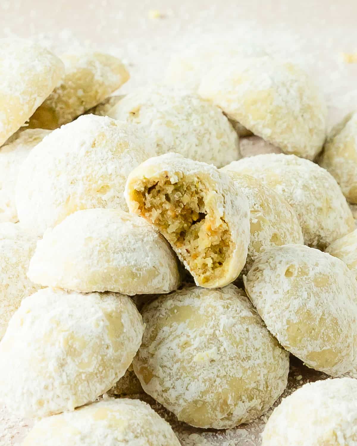 Pistachio cookies are thick, soft and buttery drop cookies made with real pistachios. These pistachio drop cookies are coated in powdered sugar giving a fresh flavor twist to the classic snowball cookie. This recipe for pistachio cookies is quick and easy and makes the perfect festive cookie for any occasion.