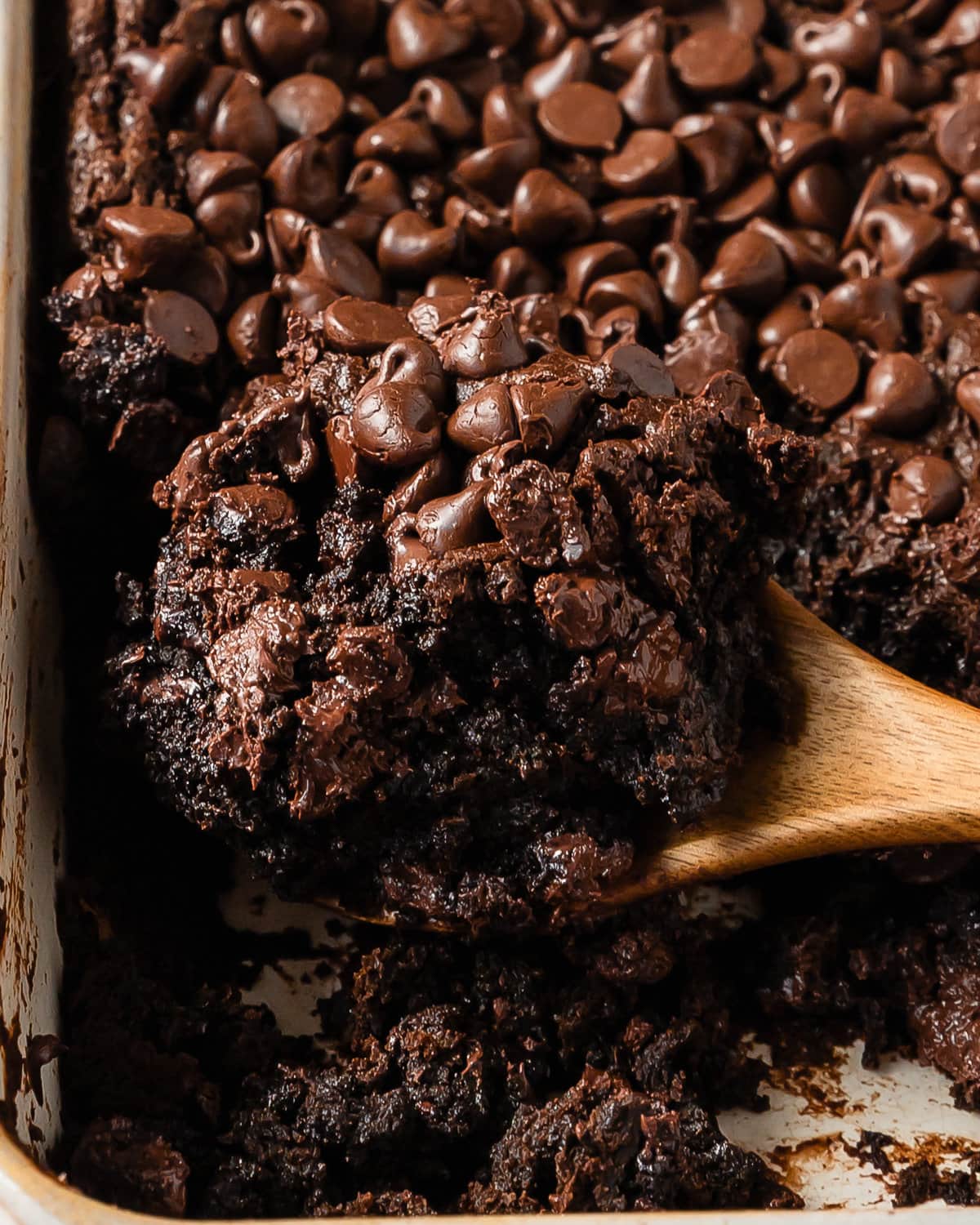 Chocolate dump cake is a quick, easy to make and rich chocolate dessert. This chocolate dump cake recipe is made from moist chocolate cake mix, creamy chocolate pudding and sweet chocolate chips. Top this decadent chocolate pudding dump cake with cold vanilla ice cream for the perfect dessert. 
