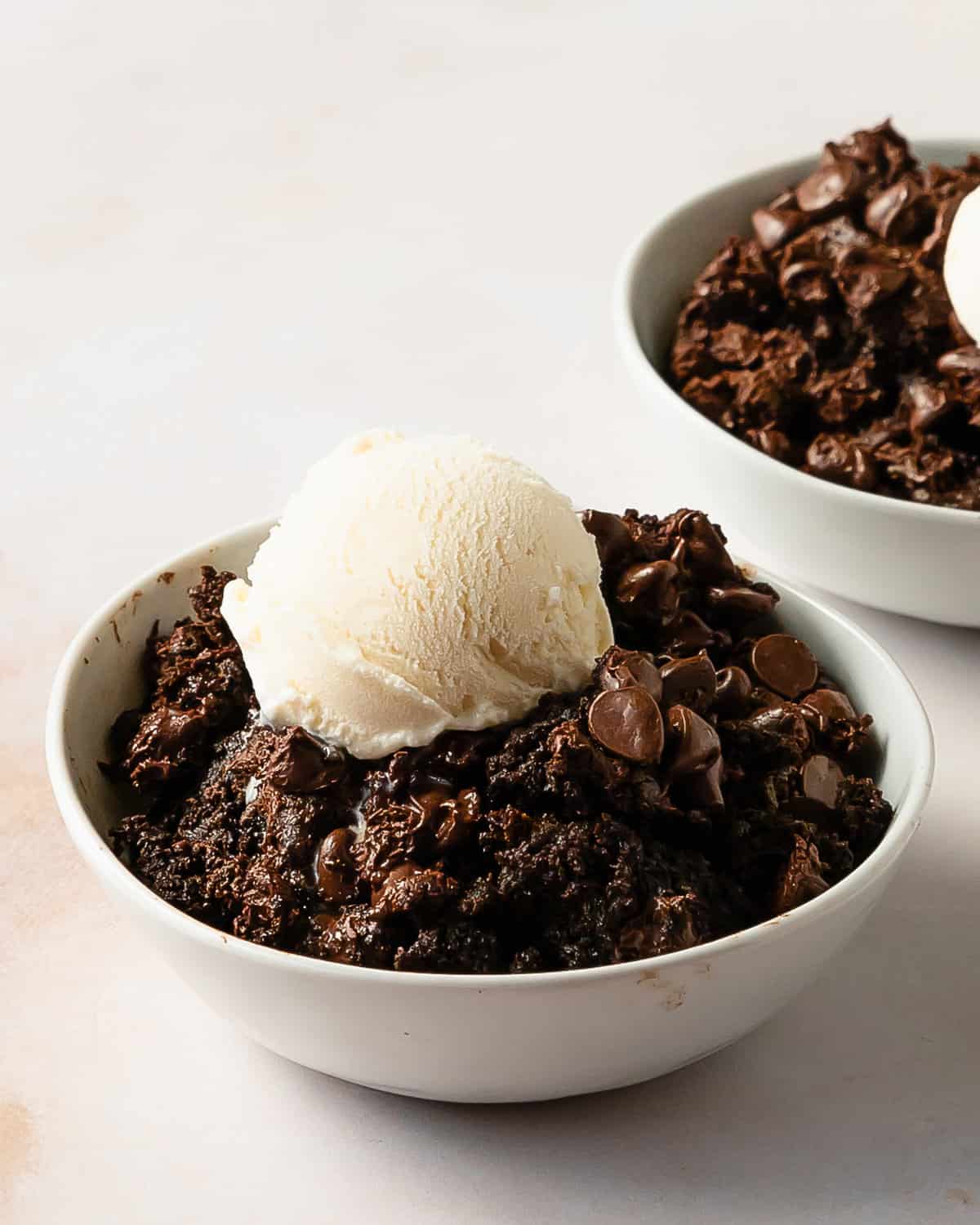 Chocolate dump cake is a quick, easy to make and rich chocolate dessert. This chocolate dump cake recipe is made from moist chocolate cake mix, creamy chocolate pudding and sweet chocolate chips. Top this decadent chocolate pudding dump cake with cold vanilla ice cream for the perfect dessert.