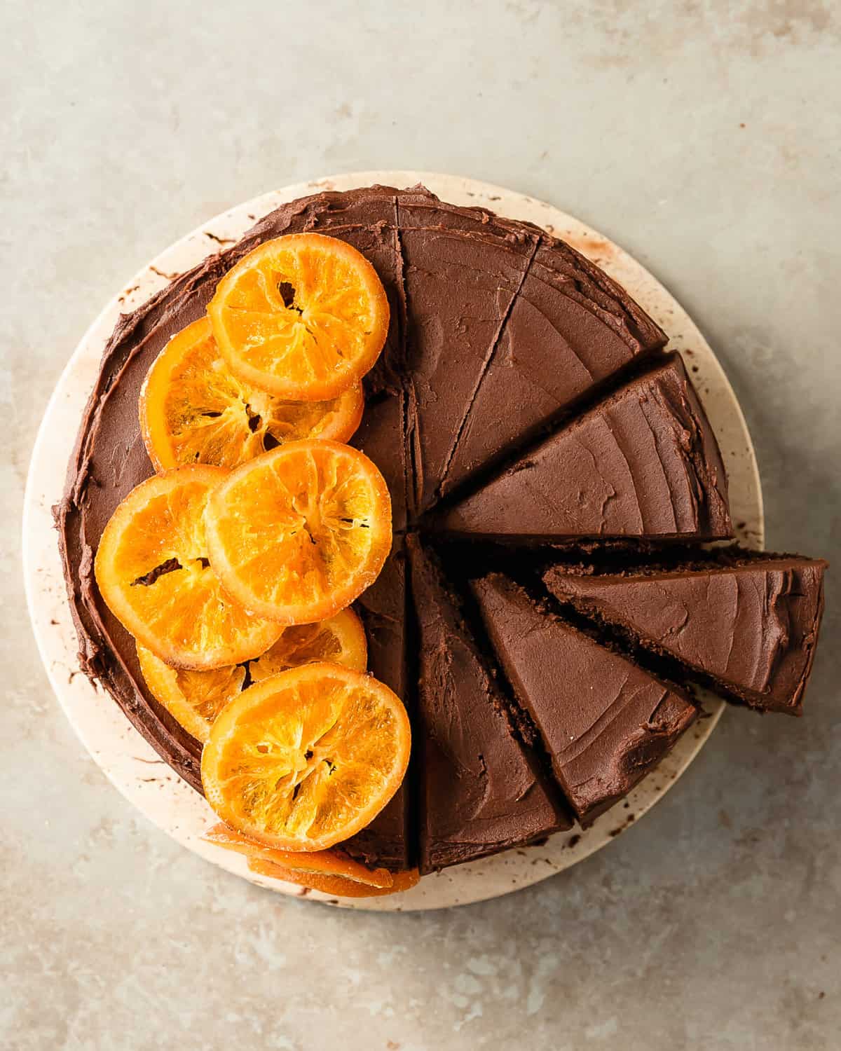Chocolate orange cake is a rich, moist and decadent chocolate cake filled with fresh orange flavor. This orange chocolate cake is layered with a whipped chocolate orange frosting and orange marmalade. Despite it’s bakery worthy appearance, this easy to make chocolate and orange cake is easy to make and is perfect for any holiday or celebratory dessert. 