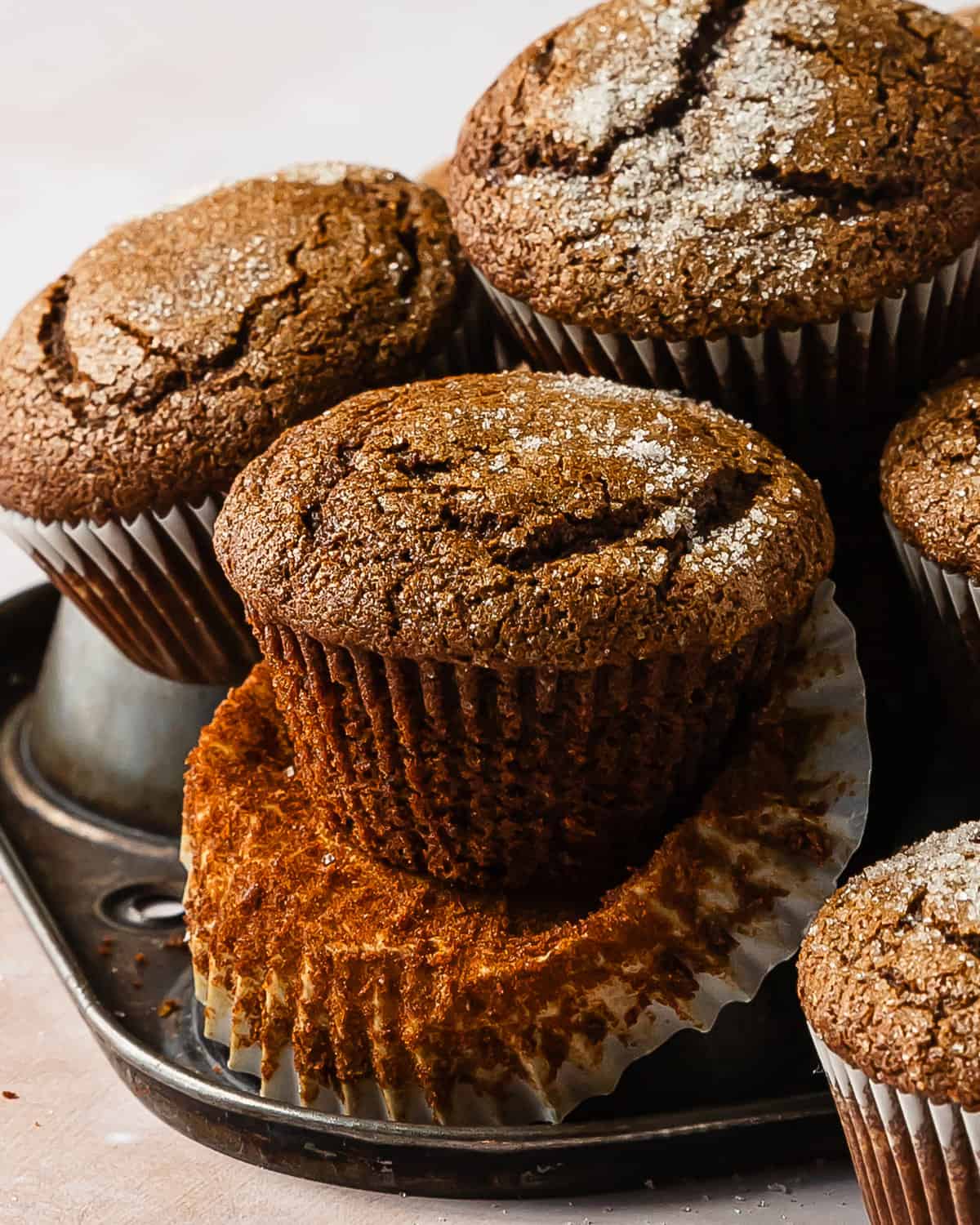 Gingerbread muffins are soft and fluffy, bakery style molasses muffins. They are filled with lots of cozy warming spices and are topped with crunchy sugar. These ginger muffins are easy to make and will be your favorite winter muffin recipe. 