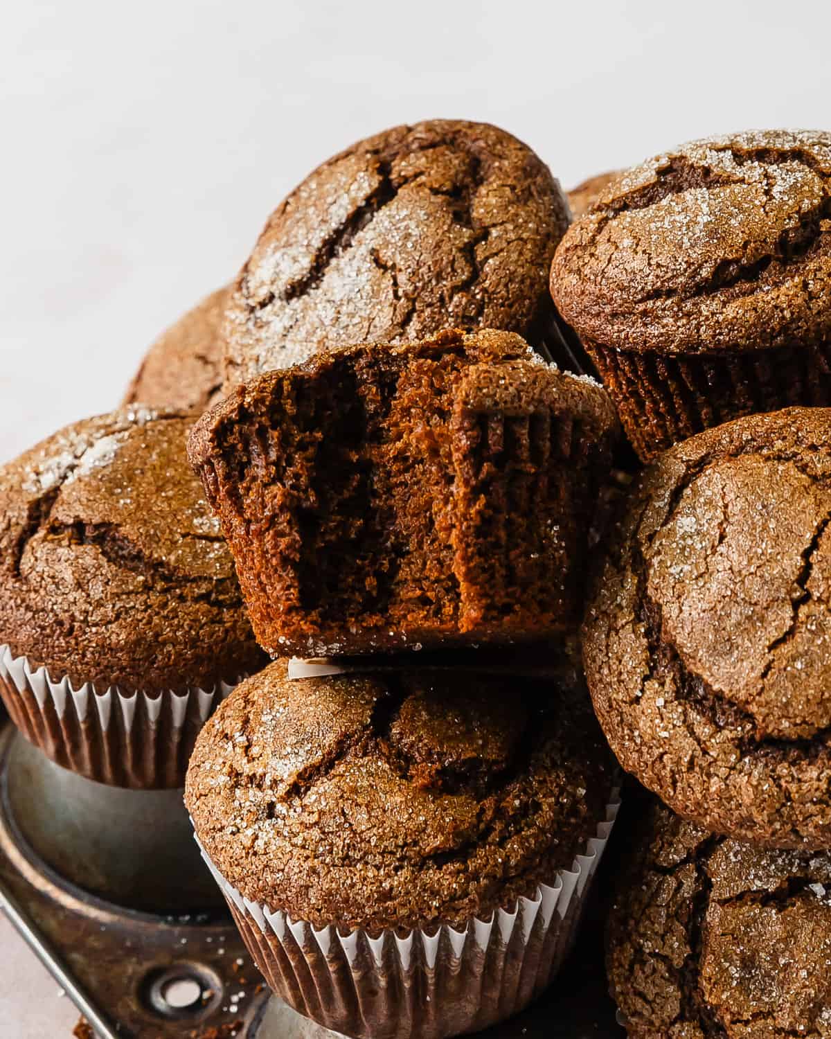 Gingerbread muffins are soft and fluffy, bakery style molasses muffins. They are filled with lots of cozy warming spices and are topped with crunchy sugar. These ginger muffins are easy to make and will be your favorite winter muffin recipe. 