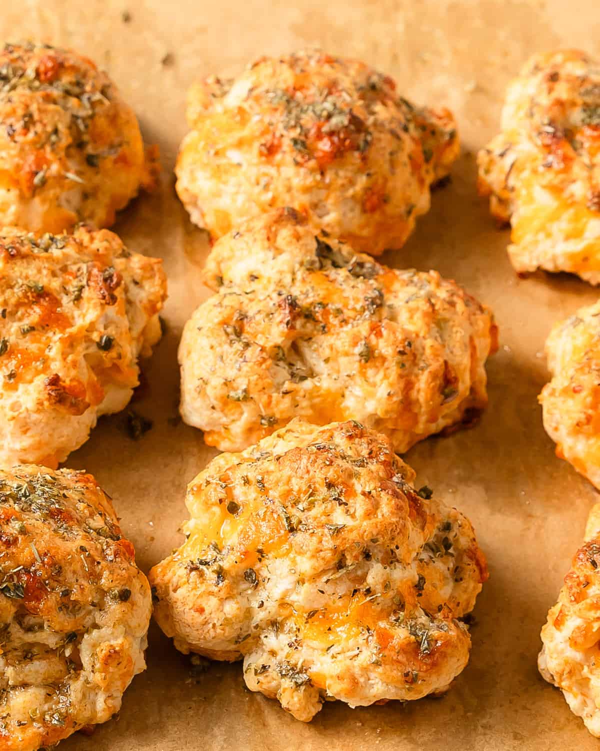 Bisquick cheddar biscuits are buttery and flaky cheddar biscuits topped with an herby garlic butter sauce. This cheddar bay biscuit copycat recipe is quick and easy to make using 6 simple pantry ingredients. These garlic cheddar Bisquick drop biscuits are just as good, if not better than the ones you’ll find at Red Lobster.