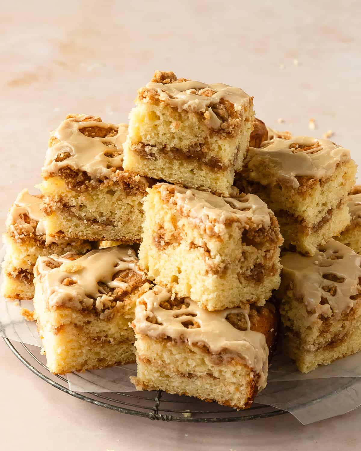 Buttermilk coffee cake is a soft, moist, fluffy and buttery vanilla cake layered with an easy cinnamon streusel. This coffee cake with buttermilk is topped with the same cinnamon streusel and  creamy vanilla glaze. Make this cinnamon streusel coffee cake for a cozy breakfast, brunch or dessert. 