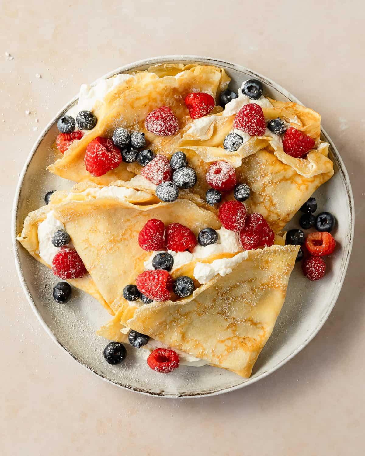 Crepes with pancake mix is a quick and easy way to make thin, buttery and delicious crepes in a fraction of the time. Learn how to make these irresistible crepe pancakes using basic pantry ingredients, in a few simple steps. Fill these pancake mix crepes with fresh berries and whipped cream for the perfect breakfast. 