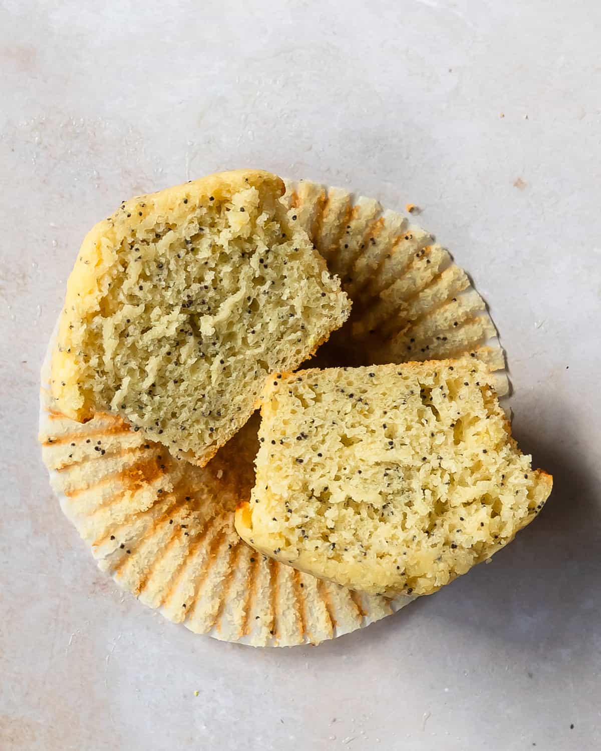Lemon poppy seed muffins are fluffy, moist and tangy bakery style muffins studded with crunchy poppy seeds and bursting with fresh citrus flavor. After baking, the poppy seed muffin tops are brushed with a bright, sweet and tart lemon simple syrup glaze. 