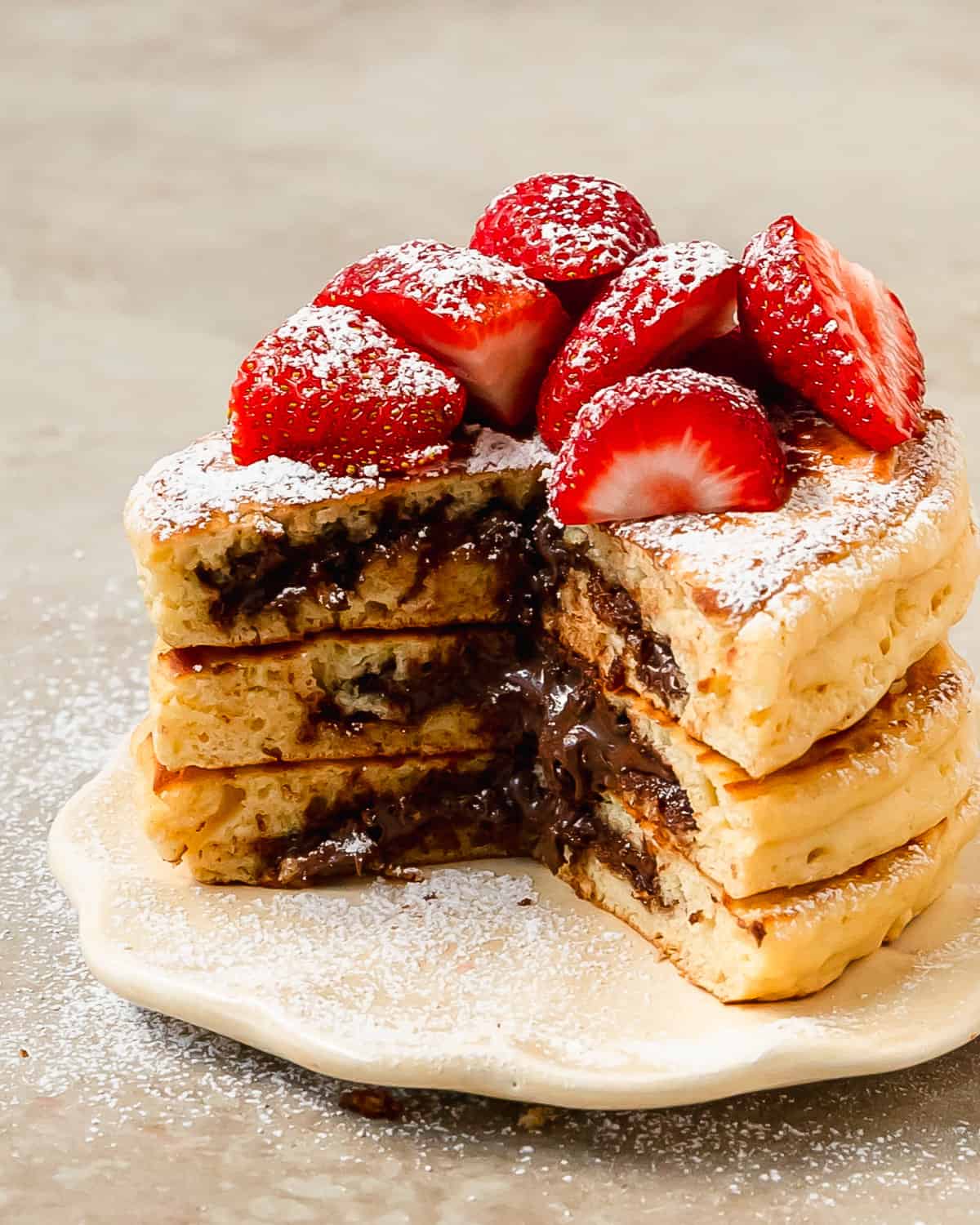 Nutella pancakes are light, fluffy and flavorful pancakes stuffed with creamy Nutella. Learn how to make these decadent and incredibly delicious Nutella stuffed pancakes in a few easy steps. A stack of these from homemade pancakes with Nutella makes the perfect special breakfast everyone will love.