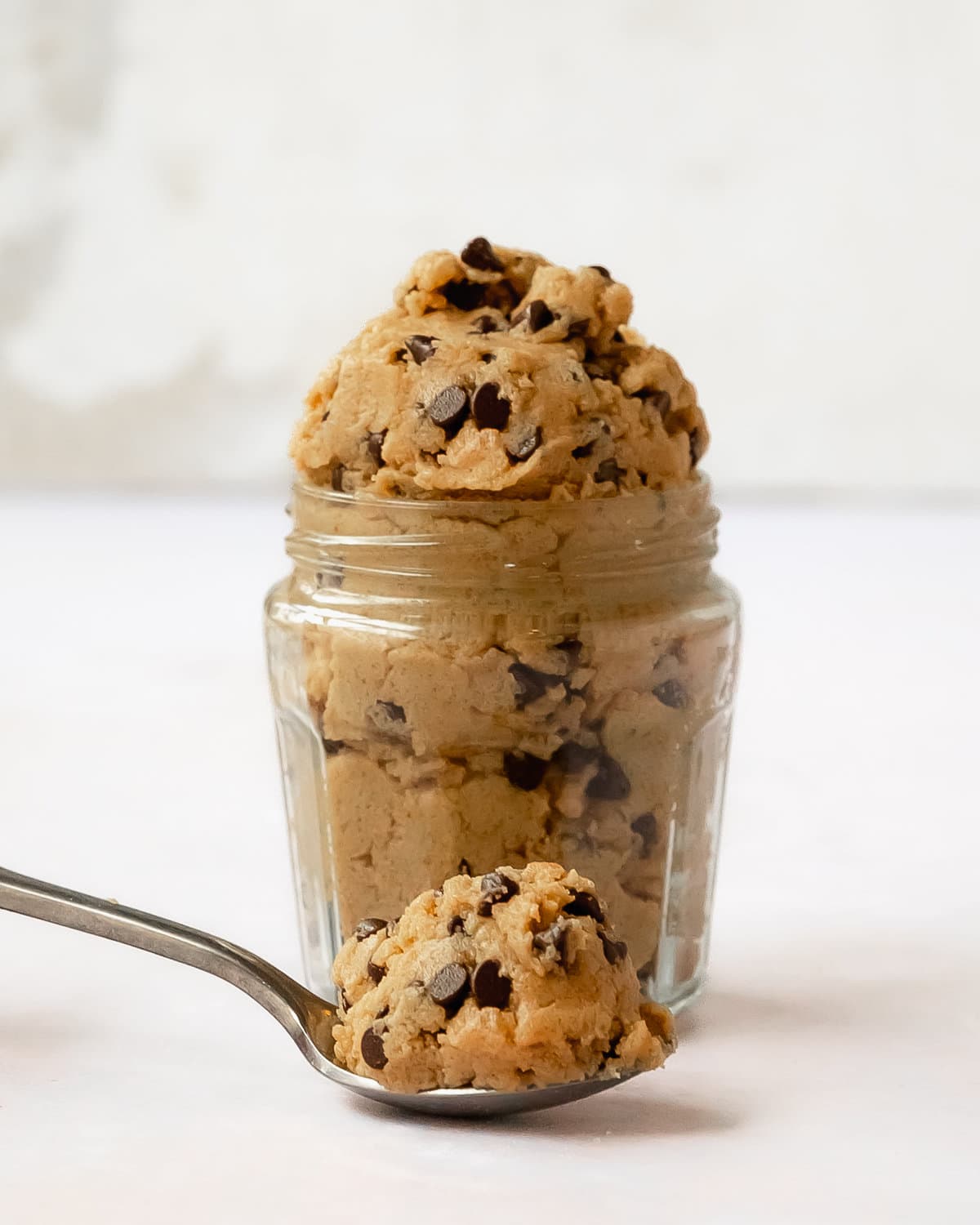 Vegan cookie dough is a quick and easy edible chocolate chip cookie dough. This vegan edible cookie dough is made with simple ingredient, is gluten and dairy free and can be made refined sugar free, too. If you’re a fan of eating scoops of cookie dough by the spoonful, this vegan chocolate chip cookie dough is for you!
