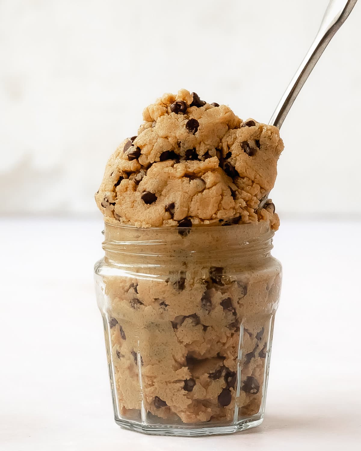 Vegan cookie dough is a quick and easy edible chocolate chip cookie dough. This vegan edible cookie dough is made with simple ingredient, is gluten and dairy free and can be made refined sugar free, too. If you’re a fan of eating scoops of cookie dough by the spoonful, this vegan chocolate chip cookie dough is for you!
