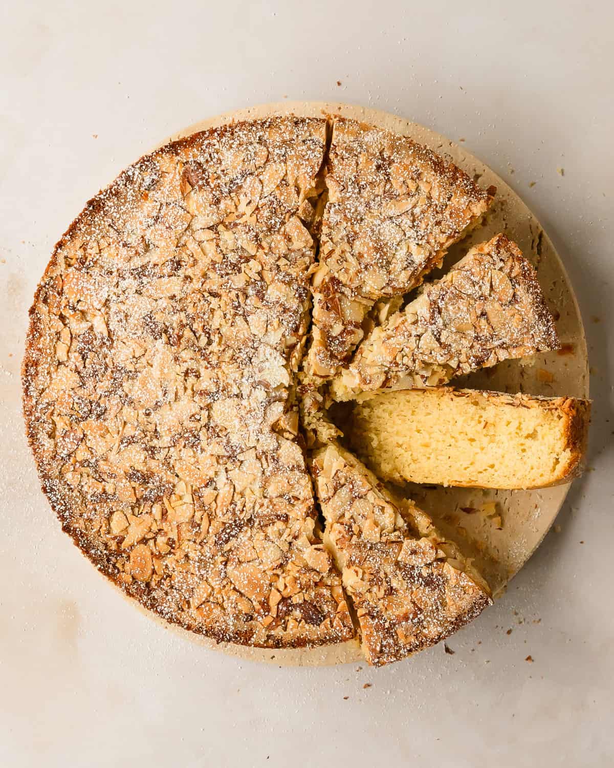 Cardamom cake is a traditional Swedish cardamom cake. This simple cardamom dessert has a buttery soft crumb and with a crunchy almond topping. Make this wonderfully easy cardamom cake recipe to pair with coffee or tea for your afternoon fika. 