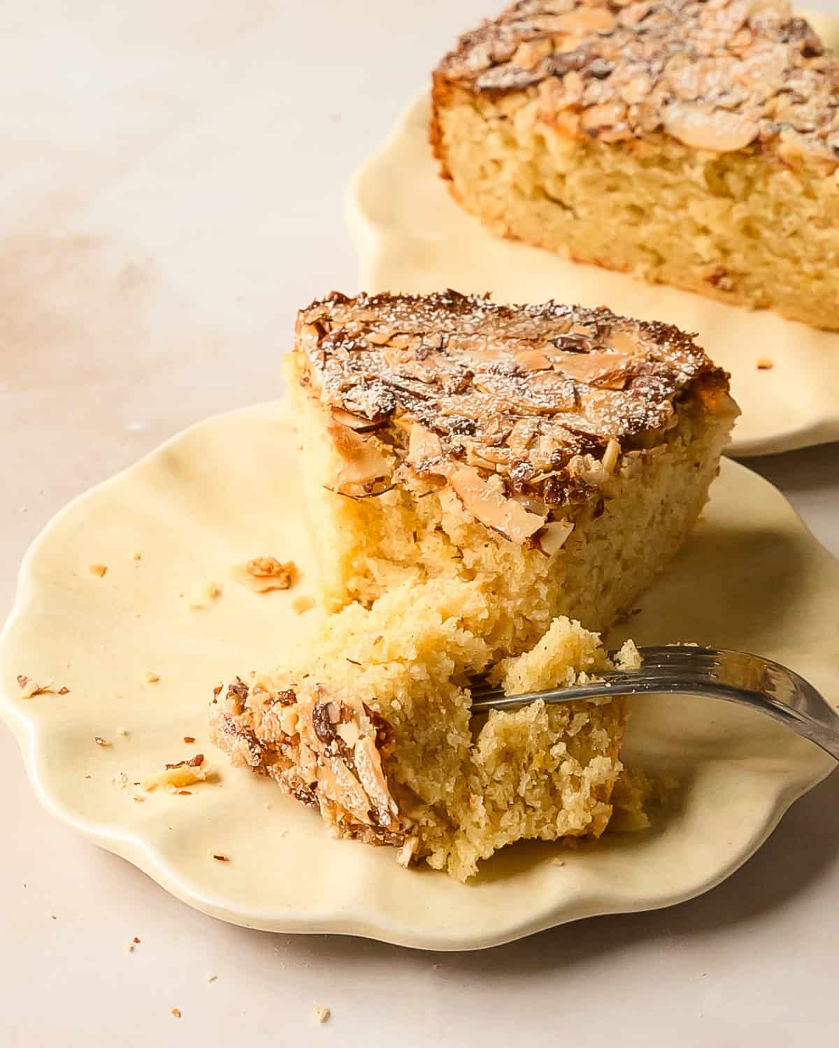 Cardamom cake is a traditional Swedish cardamom cake. This simple cardamom dessert has a buttery soft crumb and with a crunchy almond topping. Make this wonderfully easy cardamom cake recipe to pair with coffee or tea for your afternoon fika.