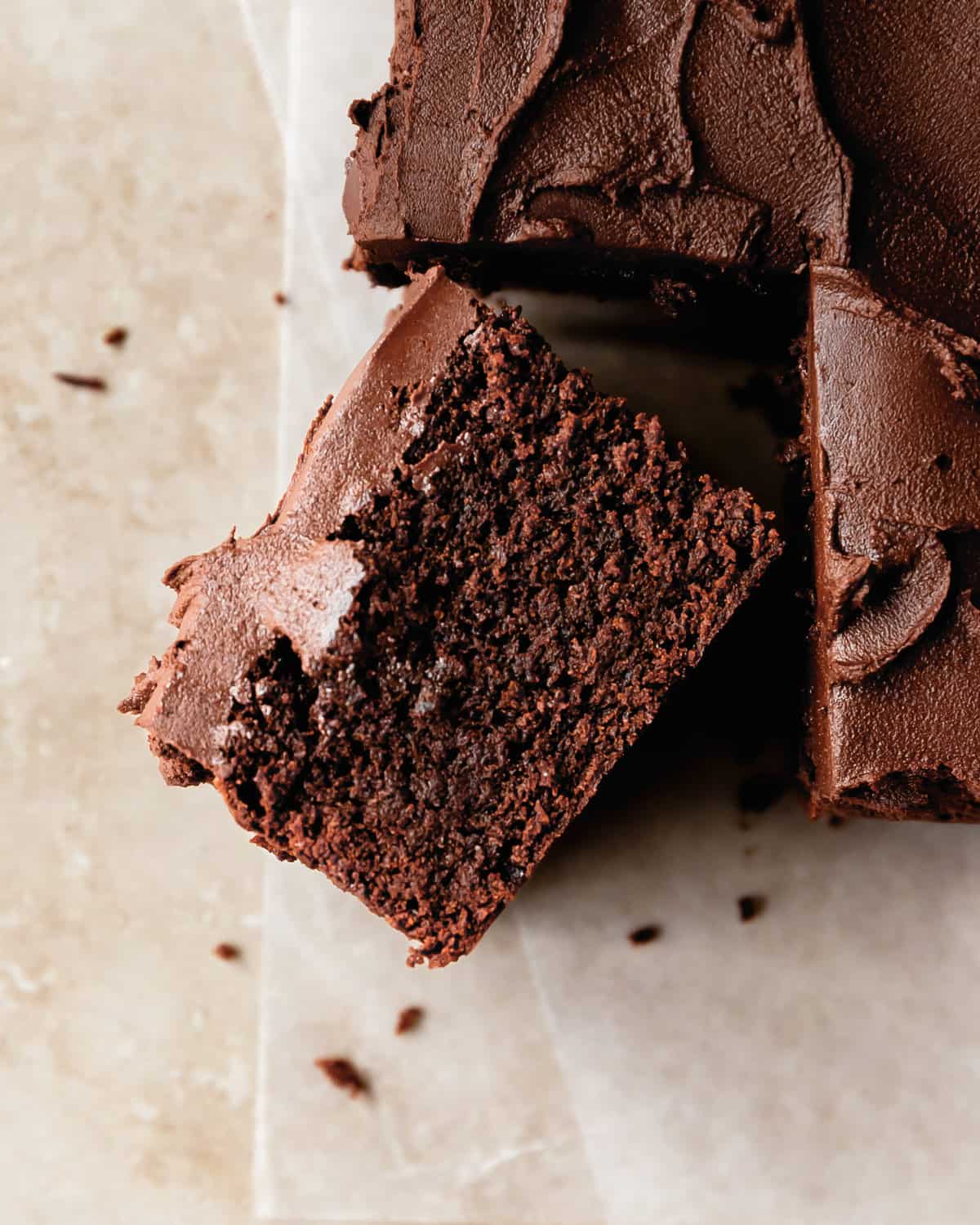 Chocolate fudge cake is a rich, dense moist and fudgy chocolate cake topped with a creamy chocolate ganache frosting. This fudge cake recipe is easy to make in one bowl and is the perfect simple, but decadent fudgy chocolate cake. 